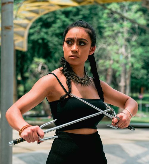 Person in a warrior yoga pose looking confident and strong.