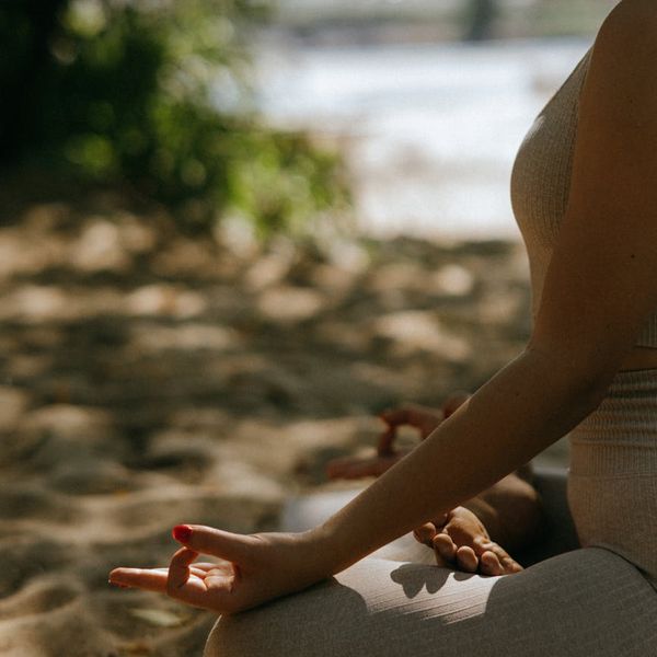 Woman meditating peacefully in a calm, serene environment.